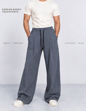 Model wearing blue Korean baggy pants, front view showing wide-leg silhouette and front pleats