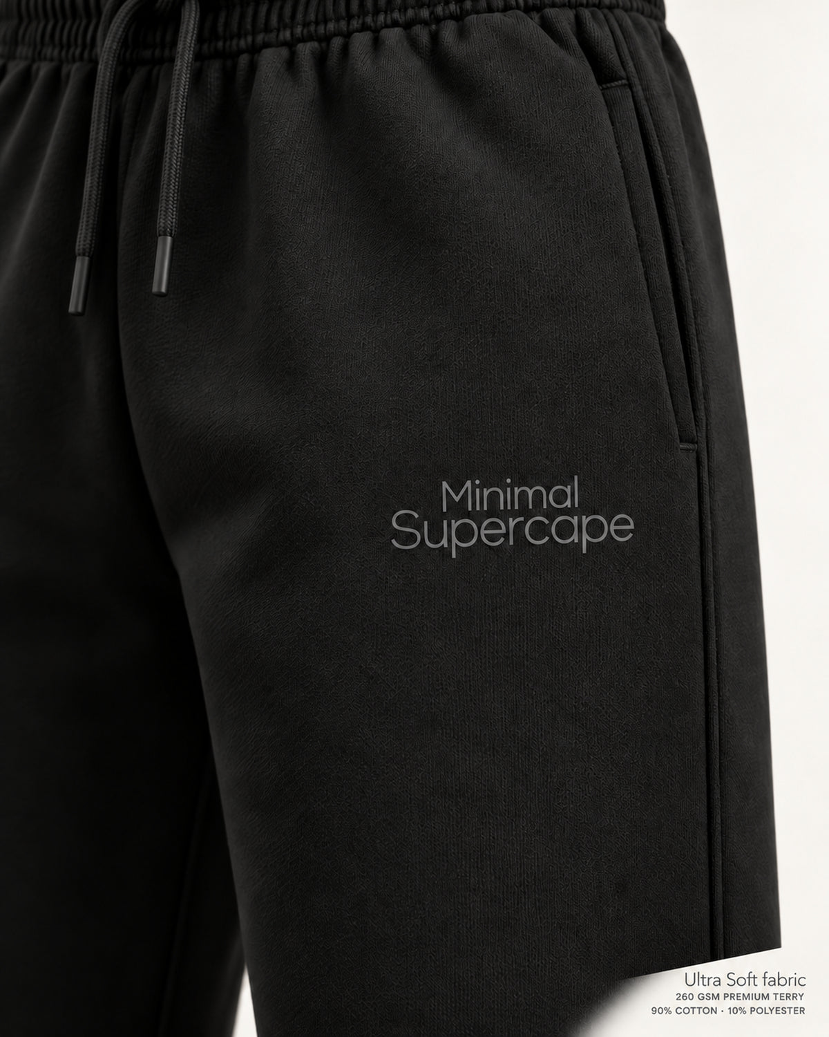 Minimal Black Unisex Sweatpants — close-up of the thigh wordmark, Ultra Soft fabric