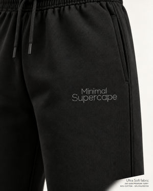 Minimal Black Unisex Sweatpants — close-up of the thigh wordmark, Ultra Soft fabric