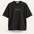 Minimal Black Oversized T-Shirt – premium front view with Minimal Supercape chest typography and SuperCape neck label; 240 GSM premium fabric, oversized drop shoulder T-shirt, 100% cotton
