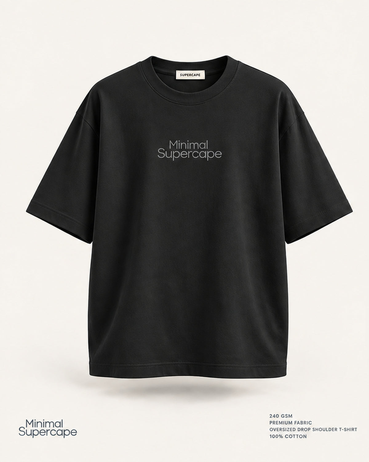 Minimal Black Oversized T-Shirt – premium front view with Minimal Supercape chest typography and SuperCape neck label; 240 GSM premium fabric, oversized drop shoulder T-shirt, 100% cotton