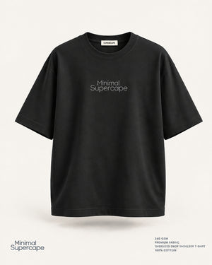 Minimal Black Oversized T-Shirt – premium front view with Minimal Supercape chest typography and SuperCape neck label; 240 GSM premium fabric, oversized drop shoulder T-shirt, 100% cotton