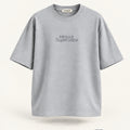 Minimal Grey Oversized T-Shirt – premium front view with Minimal Supercape chest typography and SuperCape neck label; 240 GSM premium fabric, oversized drop shoulder T-shirt, 100% cotton