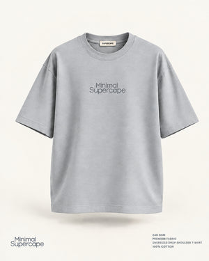 Minimal Grey Oversized T-Shirt – premium front view with Minimal Supercape chest typography and SuperCape neck label; 240 GSM premium fabric, oversized drop shoulder T-shirt, 100% cotton