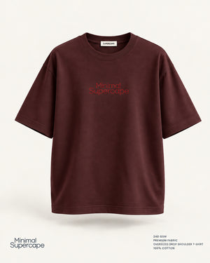 Minimal Maroon Oversized T-Shirt – premium front view with Minimal Supercape chest typography and SuperCape neck label; 240 GSM premium fabric, oversized drop shoulder T-shirt, 100% cotton