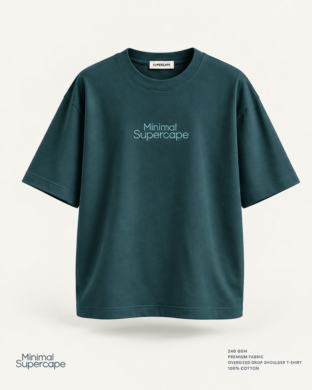 Minimal Petrol Blue Oversized T-Shirt – premium front view with Minimal Supercape chest typography and SuperCape neck label; 240 GSM premium fabric, oversized drop shoulder T-shirt, 100% cotton