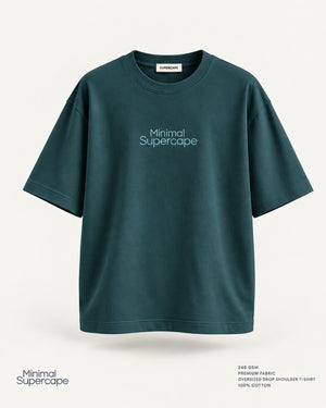 Minimal Petrol Blue Oversized T-Shirt – premium front view with Minimal Supercape chest typography and SuperCape neck label; 240 GSM premium fabric, oversized drop shoulder T-shirt, 100% cotton