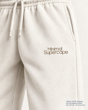 Minimal Off-White Unisex Sweatpants — warm-stone thigh wordmark close-up, Ultra Soft fabric